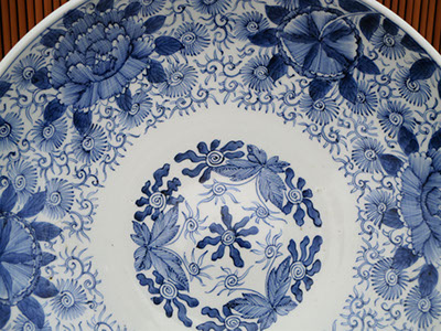 #4189  Large blue-white charger, 15.5"diam x 3"h, all hand painted. Finely detailed flowers, leaves, and vines, front and back, seal on bottom